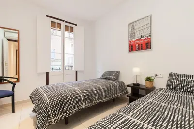 a bedroom with two beds and a picture on the wall at Flat Barcelona in Barcelona