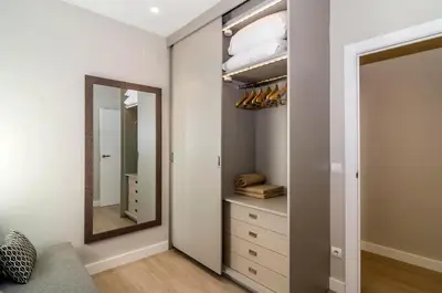 a dressing room with a mirror and a dresser at Sitges Spaces Deluxe Centre Apartment in Sitges