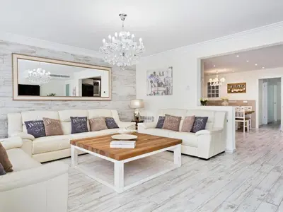 a living room with white furniture and a table at Sitges Spaces Mediterranean Apartments 4 Bedroom in Sitges