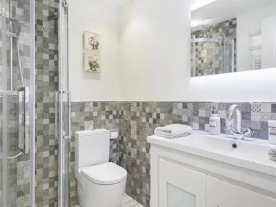 a bathroom with a toilet and a sink and a shower at Sitges Spaces Mediterranean Apartments 4 Bedroom in Sitges
