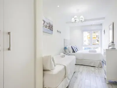 a white living room with a couch and a bed at Sitges Spaces Mediterranean Apartments 4 Bedroom in Sitges