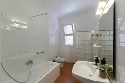 a bathroom with a tub and a toilet and a sink at Villa Can Bagués in Mataró
