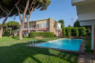 a swimming pool in a yard next to a building at Villa Can Bagués in Mataró