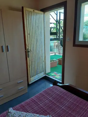 a bedroom with a bed and a sliding glass door at Habitaciones en Villa Coliving Casa Rural in San Fausto de Campcentellas