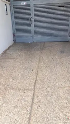 an open garage door with two metal doors at Casa Ana -Cubelles in Cubelles