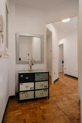 a living room with a dresser and a mirror at Nice Apartment in Barcelona