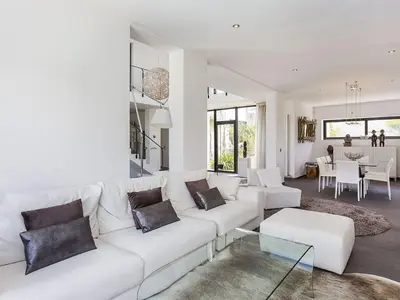 a living room with a white couch and a table at Architect modern design villa in Sitges Hills in Olivella