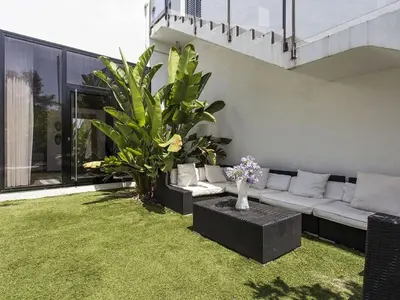 a living room with a white couch and some plants at Architect modern design villa in Sitges Hills in Olivella