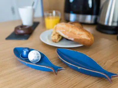 a table with two blue spoons and a plate of bread at Sitges Spaces Seaside Beach Flat- 4 Bedroom, 2 Bathroom, Terrace, Near Beach in Sitges