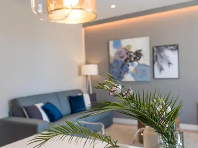 a living room with a couch and a vase with flowers at Sitges Spaces Seaside Beach Flat- 4 Bedroom, 2 Bathroom, Terrace, Near Beach in Sitges