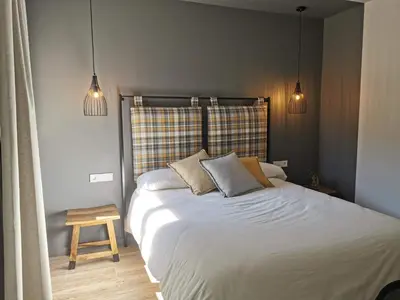 a bedroom with a large white bed with two pillows at Apartaments Agulles de Montserrat in Monistrol