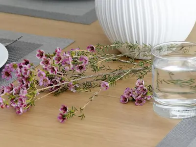 a table with purple flowers and a glass of water at Sitges Spaces Sea View Paradise- 2 Bedrooms, 2 Bathrooms, Terrace, Amazing Sea Views in Sitges