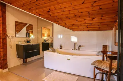 a large bathroom with a tub and a sink at Les Suites in Santa María de Palautordera