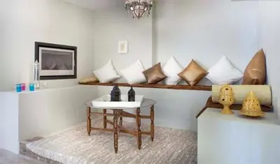 a room with a table and a bunch of pillows at Les Suites in Santa María de Palautordera