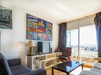a living room with a couch and a tv at Linda Vista Oasis Penthouse by Hello Homes Sitges in Sitges