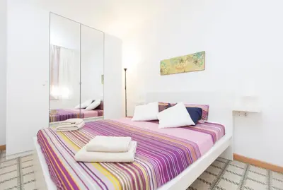 a room with two beds and a table and a chair at Stay Barcelona Plaza España Fira in Barcelona