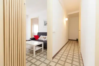 a living room with a couch and a tv at Stay Barcelona Plaza España Fira in Barcelona