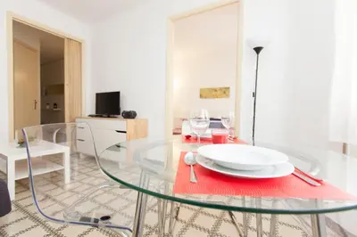 a living room with a couch and a tv at Stay Barcelona Plaza España Fira in Barcelona