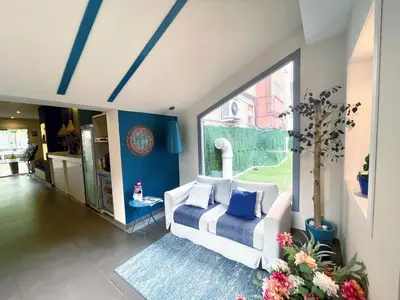 a living room with a white couch and blue walls at Hotel BESTPRICE Diagonal in Barcelona