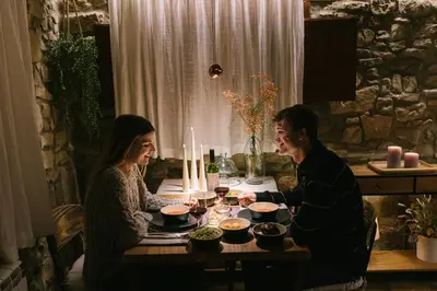 a man and woman sitting at a table with food at La Caseta del Munt in Castelltersol