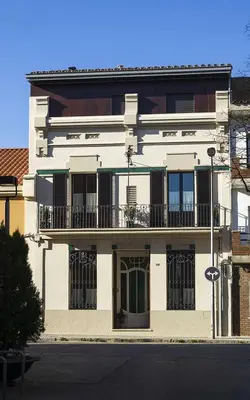a large white building with a balcony on a street at Cal Peó B&B Cardedeu in Cardedeu
