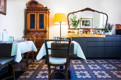 a dining room with a table and a mirror at Cal Peó B&B Cardedeu in Cardedeu