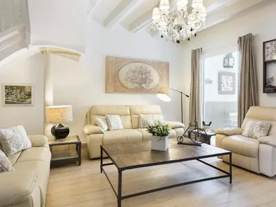 a living room with a couch and a table at Sitges Spaces Beach House-4 bedrooms, 3 Bathrooms, Large Terrace, Jacuzzi, Center-Beach in Sitges