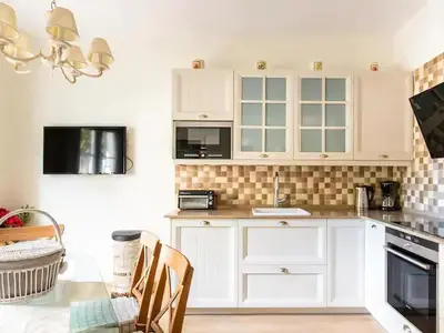 a kitchen with white cabinets and a glass table at Sitges Spaces Beach House-4 bedrooms, 3 Bathrooms, Large Terrace, Jacuzzi, Center-Beach in Sitges