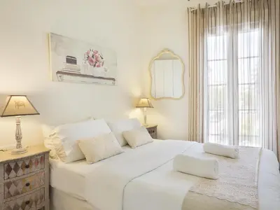 a white bedroom with a large white bed and a window at Sitges Spaces Beach House-4 bedrooms, 3 Bathrooms, Large Terrace, Jacuzzi, Center-Beach in Sitges