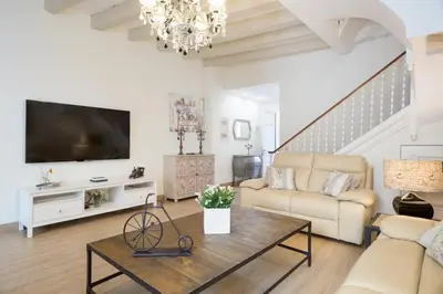 a living room with a couch and a tv at Sitges Spaces Beach House-4 bedrooms, 3 Bathrooms, Large Terrace, Jacuzzi, Center-Beach in Sitges
