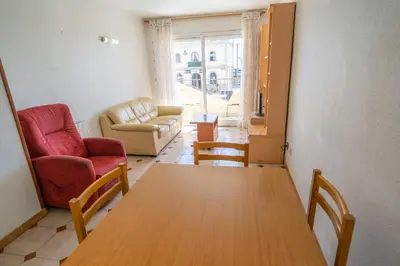a living room with a table and chairs and a couch at HomeHolidaysRentals Destan - Costa Barcelona in Pineda de Mar
