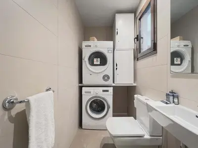 a bathroom with a washing machine and a sink at Stay U-nique Apartments Rambla Catalunya II in Barcelona