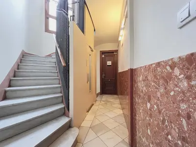a hallway with stairs in a building with a door at Stay U-nique Apartments Rambla Catalunya II in Barcelona