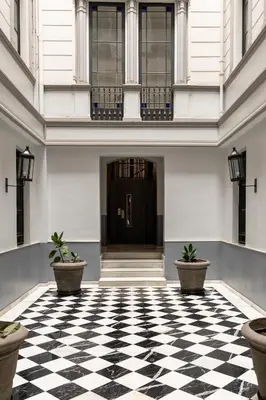 a lobby with a black and white checkered floor at Colectia Stays Pau Claris in Barcelona