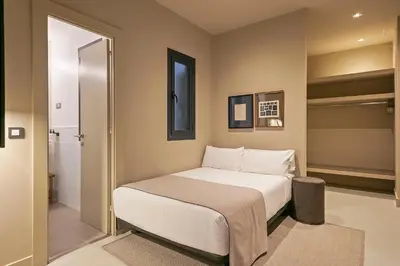 a bedroom with a bed and a walk in shower at Colectia Stays Pau Claris in Barcelona