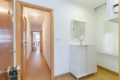 a hallway with a white cabinet and a mirror at Cadillac Check-in flexible-Bien comunicado-cerca Barcelona in Cornellà de Llobregat