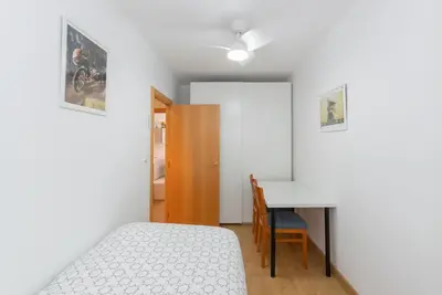 a bedroom with a bed and a desk and a table at Cadillac Check-in flexible-Bien comunicado-cerca Barcelona in Cornellà de Llobregat
