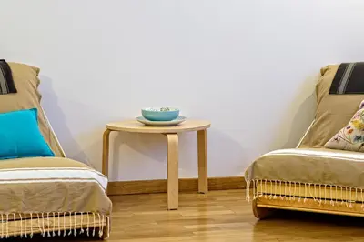 a table with a bowl on it next to two chairs at Tata's House, junto playa y Barcelona Centro in Masnou