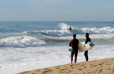 two men standing on the beach with their surfboards at Tata's House, junto playa y Barcelona Centro in Masnou