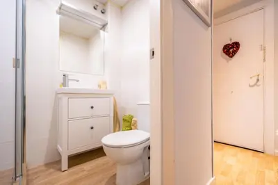 a white bathroom with a toilet and a sink at HomeHolidaysRentals Plume - Costa Barcelona in Pineda de Mar