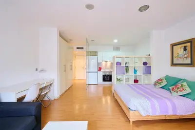 a bedroom with a bed and a desk in a room at Precioso Loft en Badalona Centro in Badalona