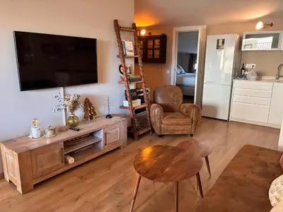 a living room with a flat screen tv on a wall at PassiveRooms in Vilanova i la Geltrú
