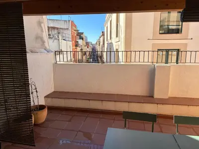 a balcony with a bench on a building at PassiveRooms in Vilanova i la Geltrú