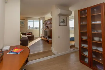 a living room with a dining table and a living room at Gaudi penthouse with terrace views in Barcelona