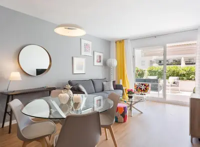 a living room with a glass table and a couch at SITGES POOL & SEA TERRACE Luxury, comfort, unbeatable location in Sitges