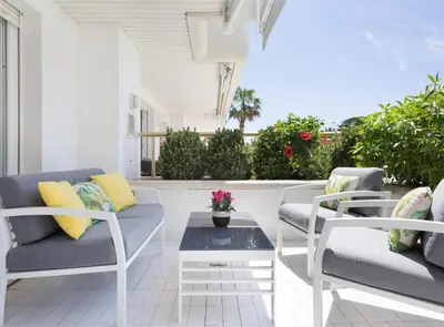 a living room with chairs and a table at SITGES POOL & SEA TERRACE Luxury, comfort, unbeatable location in Sitges