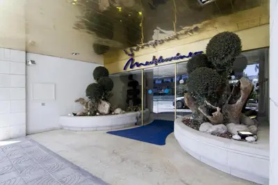 a store front with two large pots with trees in it at SITGES POOL & SEA TERRACE Luxury, comfort, unbeatable location in Sitges