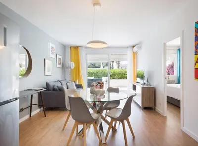 a kitchen and living room with a table and chairs at SITGES POOL & SEA TERRACE Luxury, comfort, unbeatable location in Sitges