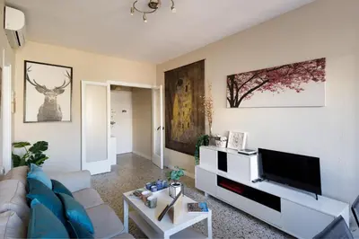 a living room with a couch and a flat screen tv at Mercat Sant Antoni 1 in Barcelona