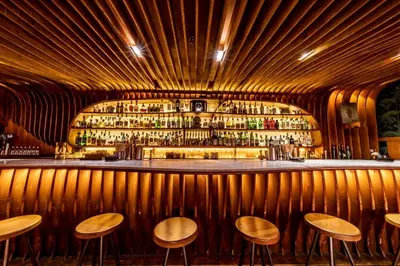 a bar with wooden walls and wooden stools at Mercat Sant Antoni 1 in Barcelona